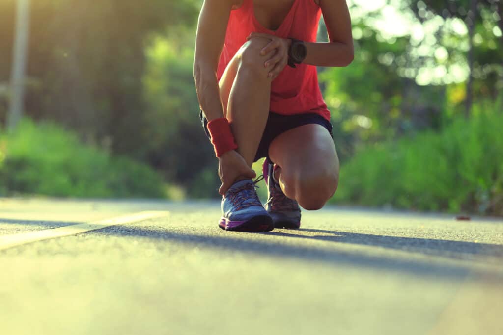 young fitness woman runner got sports injury on knee