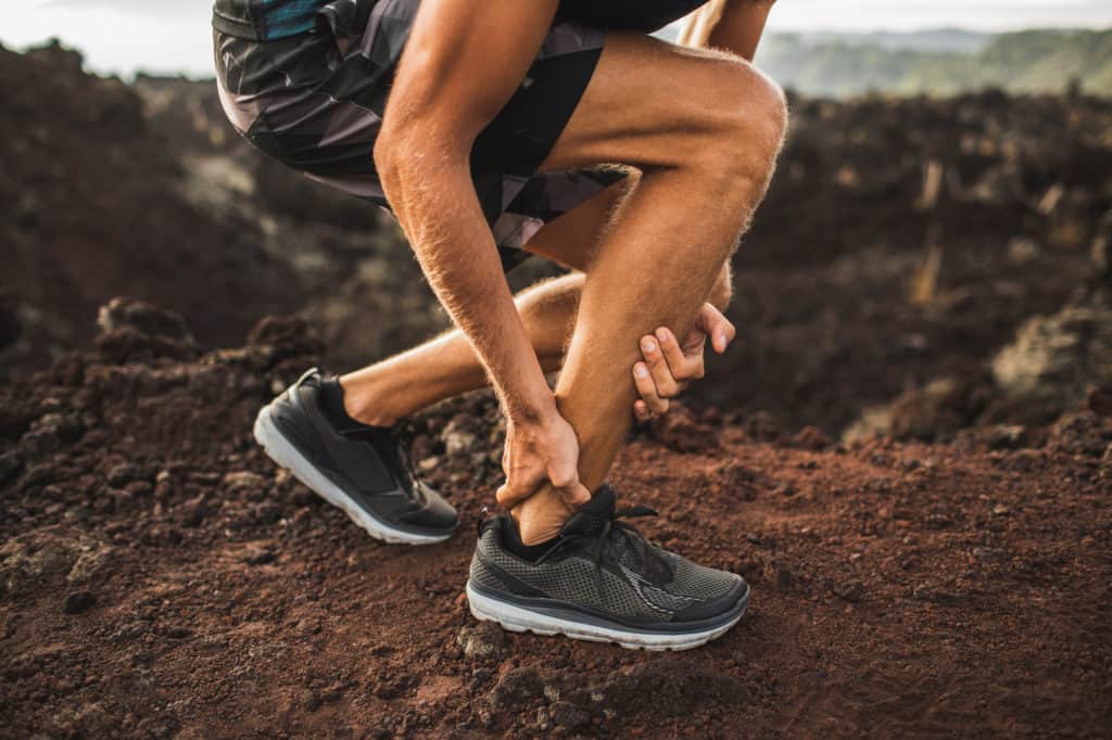 male runner down injured with Achilles Tendonitis