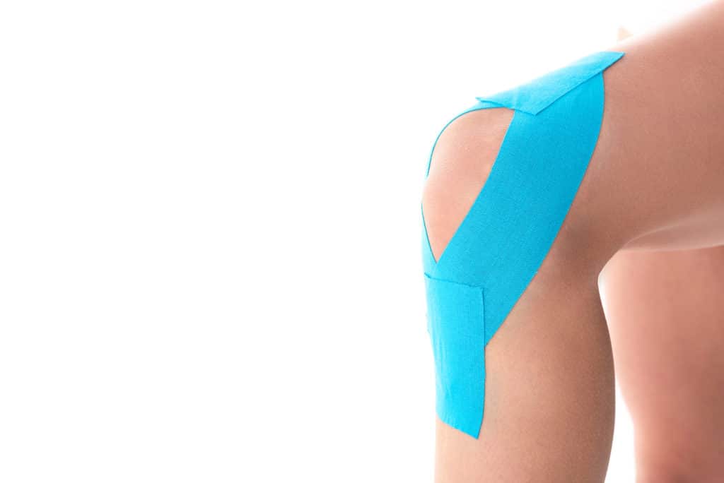 woman with knee kinesiology tape on 