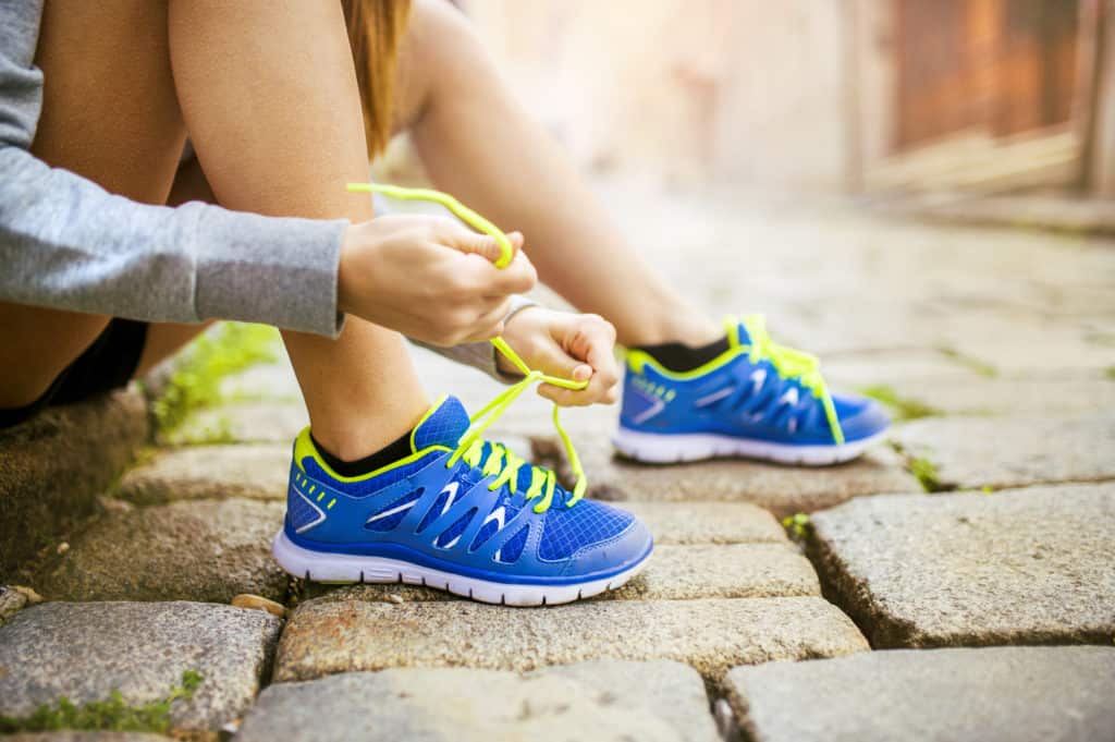 woman tying her running shoes