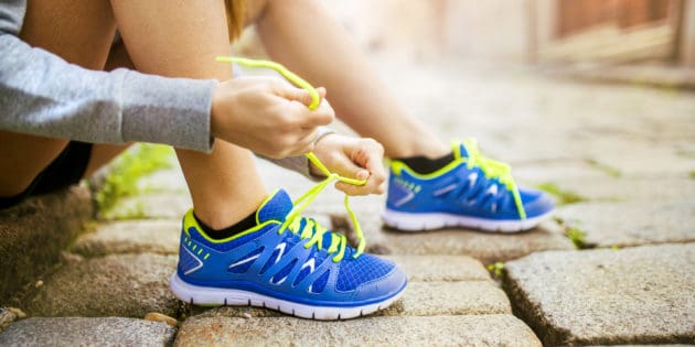 woman tying her running shoes