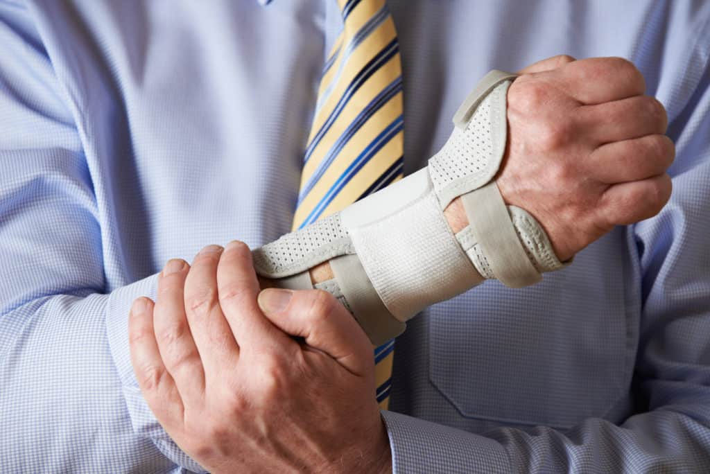 Man wearing wrist brace to try and treat carpal tunnel syndrome 