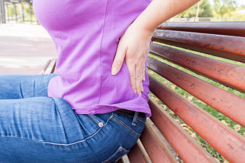 Do you have an Aching Back? - Woman with low back pain Fotolia 95795910