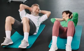 elderly couple exercising side-by-side in the gym