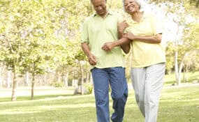 elderly couple walking in the park