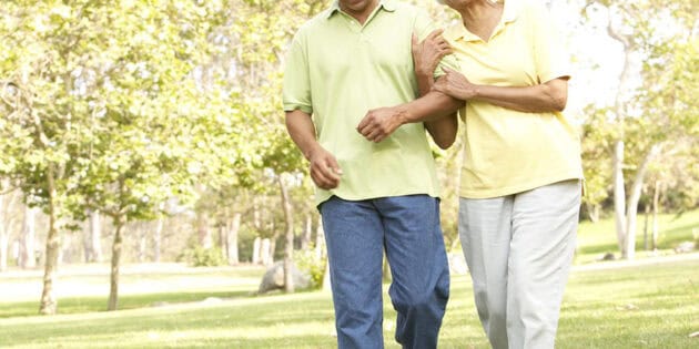 elderly couple walking in the park