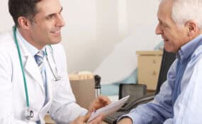 doctor talking to senior man about surgery