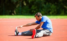 a man stretching on a track