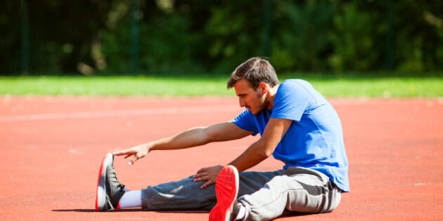 a man stretching on a track