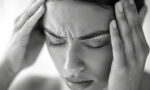 7 Highly Effective Ways to Relieve Tension Headaches Naturally - vecteezy a woman with her hands on her head looking sad concept of 49371778 1