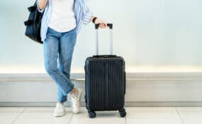 sciatica travel tips woman with suitcase at airport