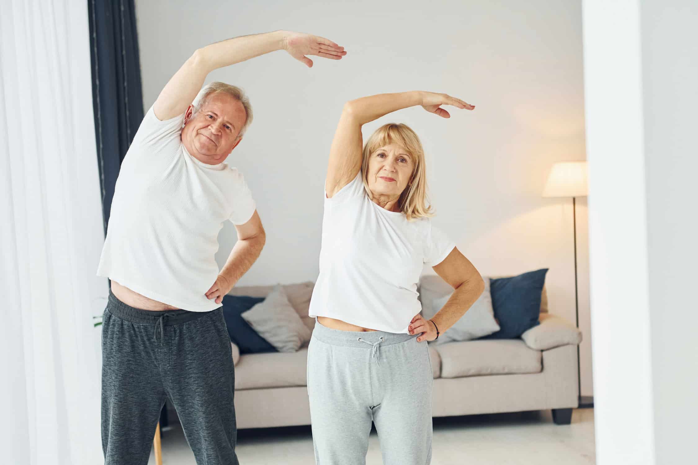 man and woman doing low impact exercise at home