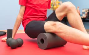 a person sitting on a roll of foam