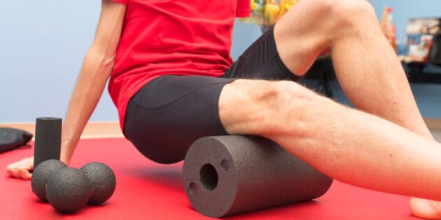 a person sitting on a roll of foam