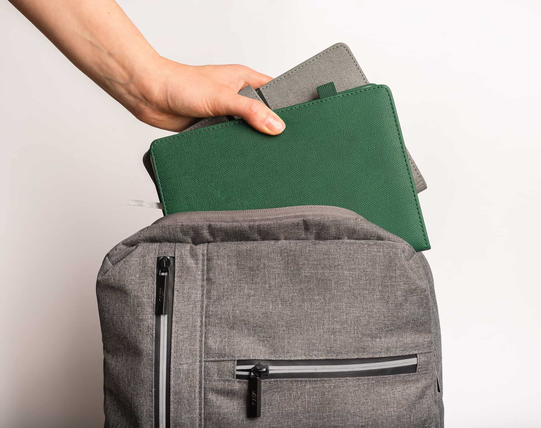 child's backpack being packed for school by parent