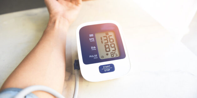 Man checking his blood pressure with a blood pressure cuff