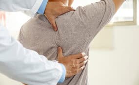 Physical therapist working with patient on spinal fusion recovery rehabilitation at Intecore Physical Therapy Southern California