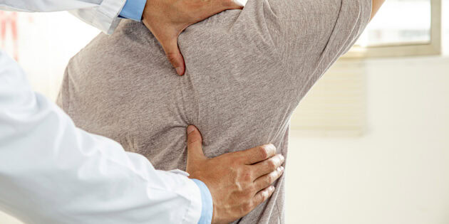 Physical therapist working with patient on spinal fusion recovery rehabilitation at Intecore Physical Therapy Southern California