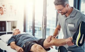 Physical therapist guiding patient through prehab knee exercises at Intecore Physical Therapy in Southern California