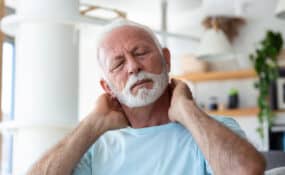 elderly man suffering from morning neck pain