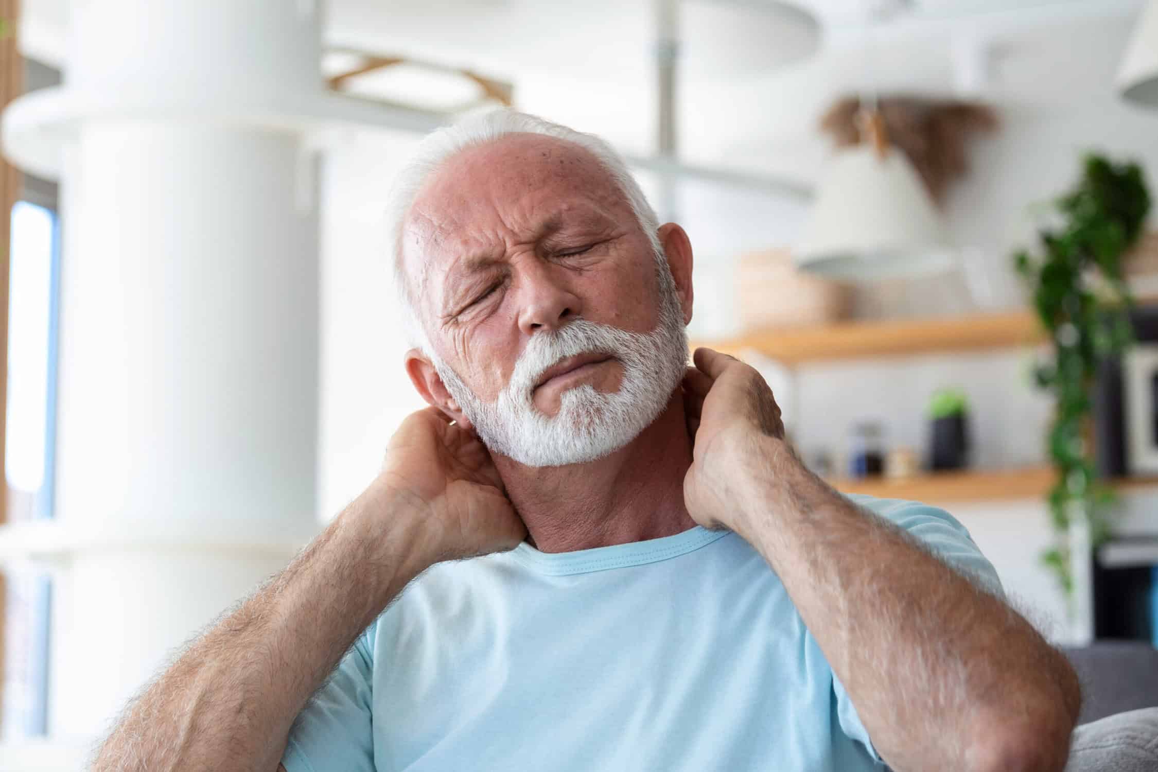 elderly man suffering from morning neck pain