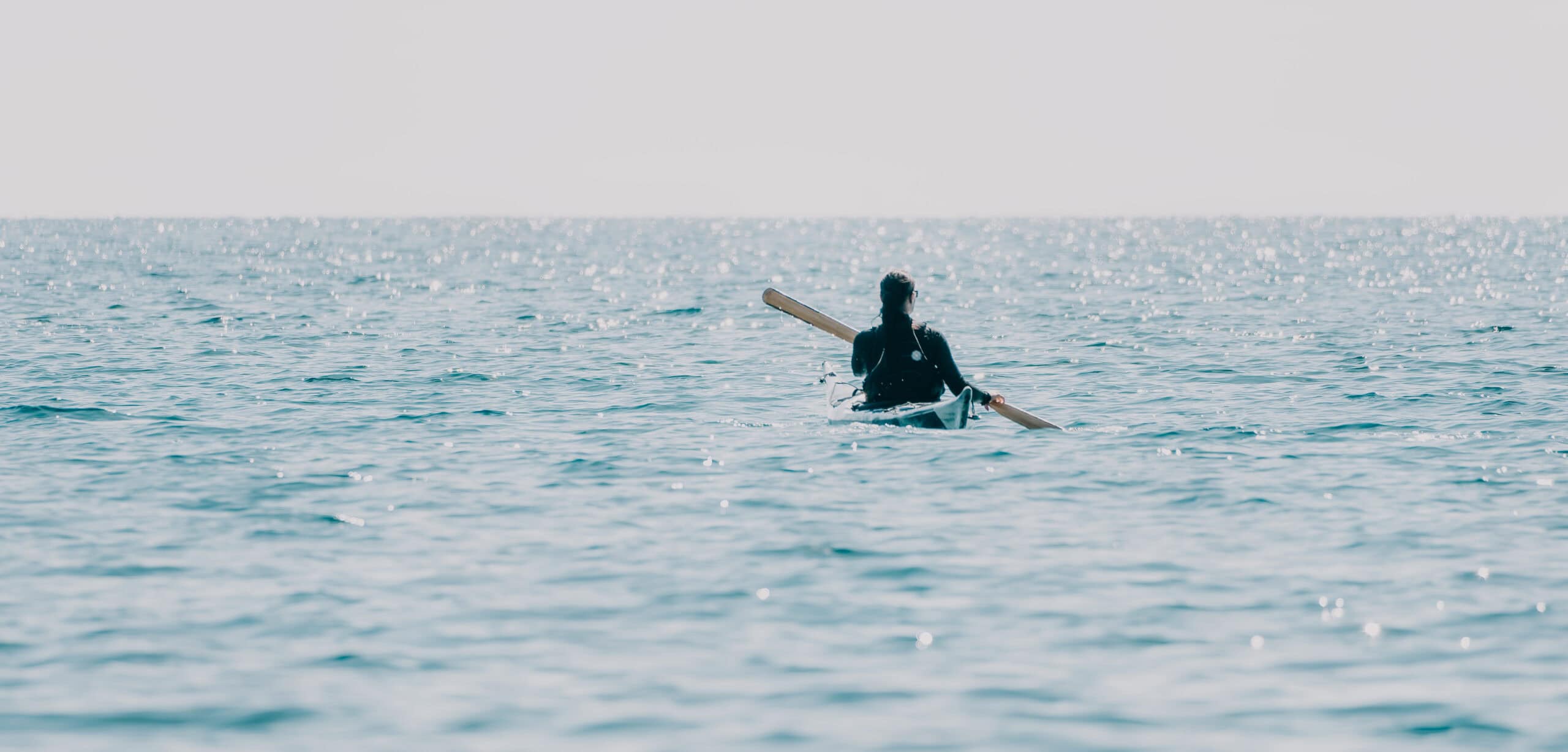 woman paddling and surfing