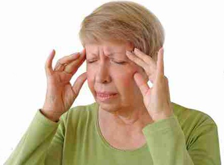 Old woman with a headache, rubbing her temples
